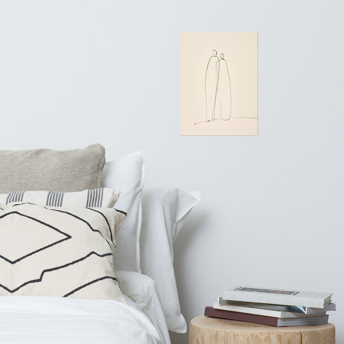 Mockup of minimalist continuous line ink drawing of two abstract figures standing together on cream paper